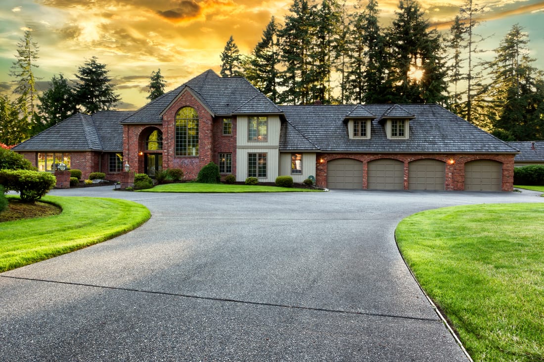 Full re-roof on a luxury brick home at golden hour